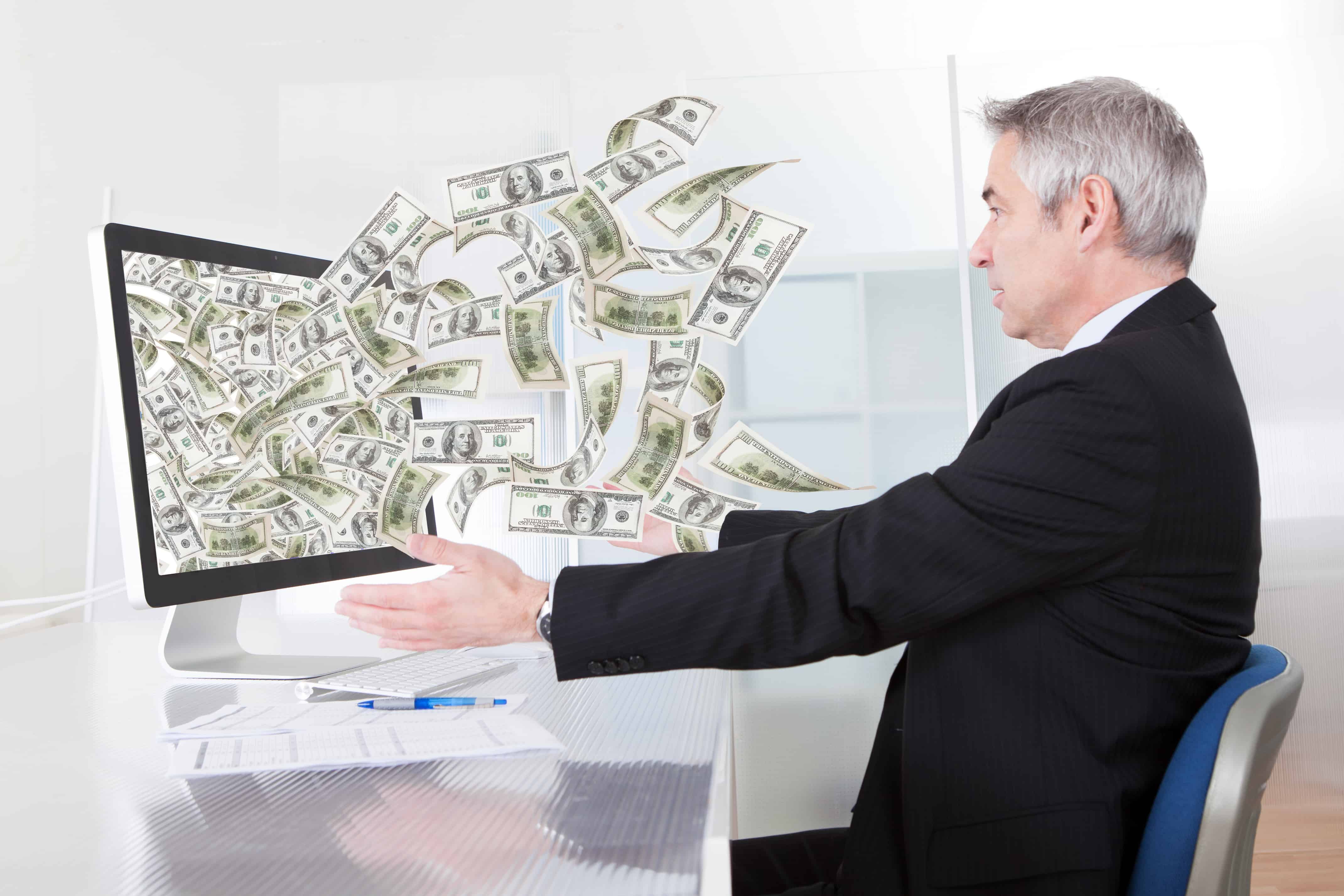 Businessman Earning Lots Of Cash In Internet