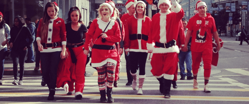 Holiday shoppers in Santa suits