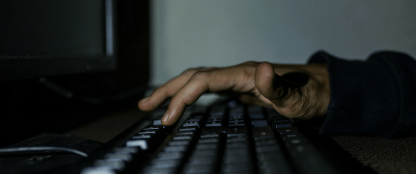 Data breach hacker typing on a keyboard