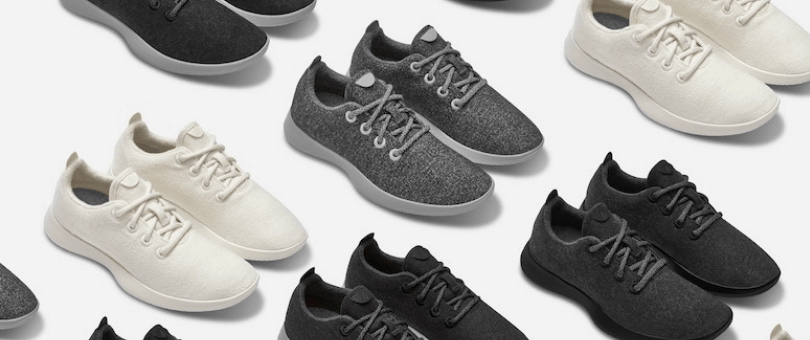 Rows of Allbirds shoes in white, black and grey