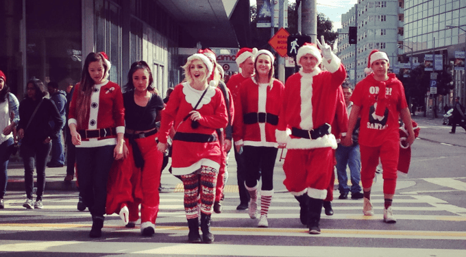 A group of Santas cross a street in San Francisco