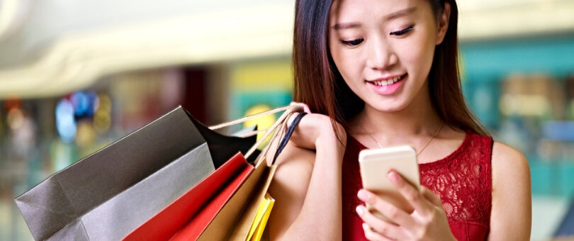 Lady Shopping looking at her cel phone