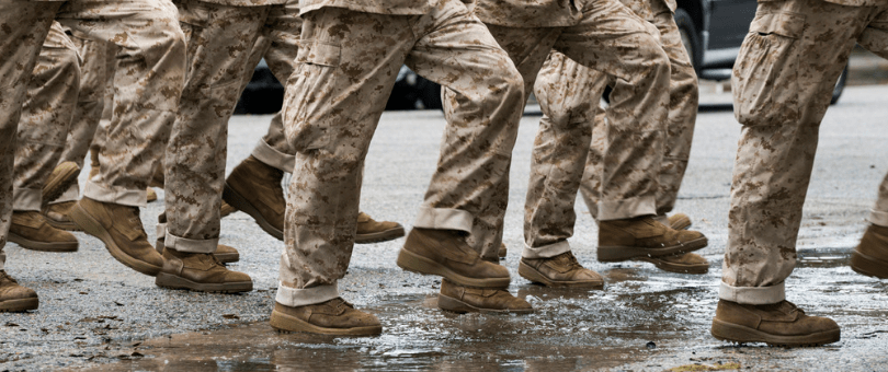 Image of solidiers' boots marching through the mud.