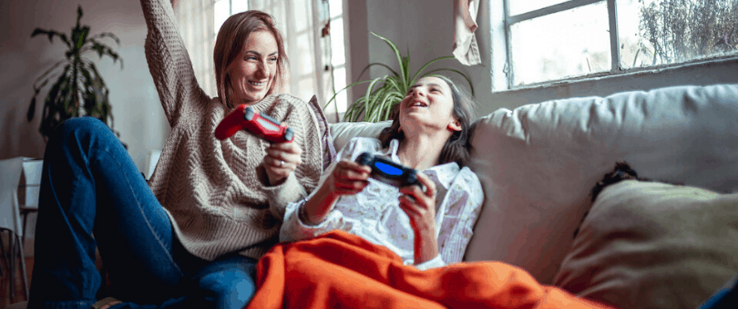 Mother & daughter playing video games during coronavirus shelter-at-home period
