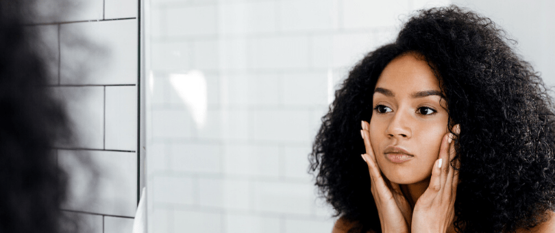 Woman looking at herself in the mirror