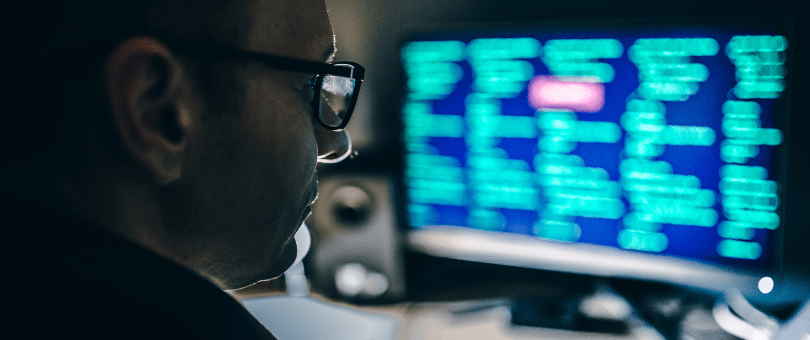 A man studying data on a computer screen