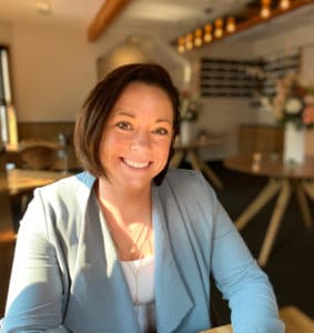 Portrait of Mallory Ames sitting at a table