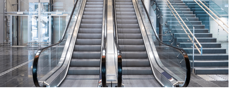 Two empty escalators in an empty retail shopping center