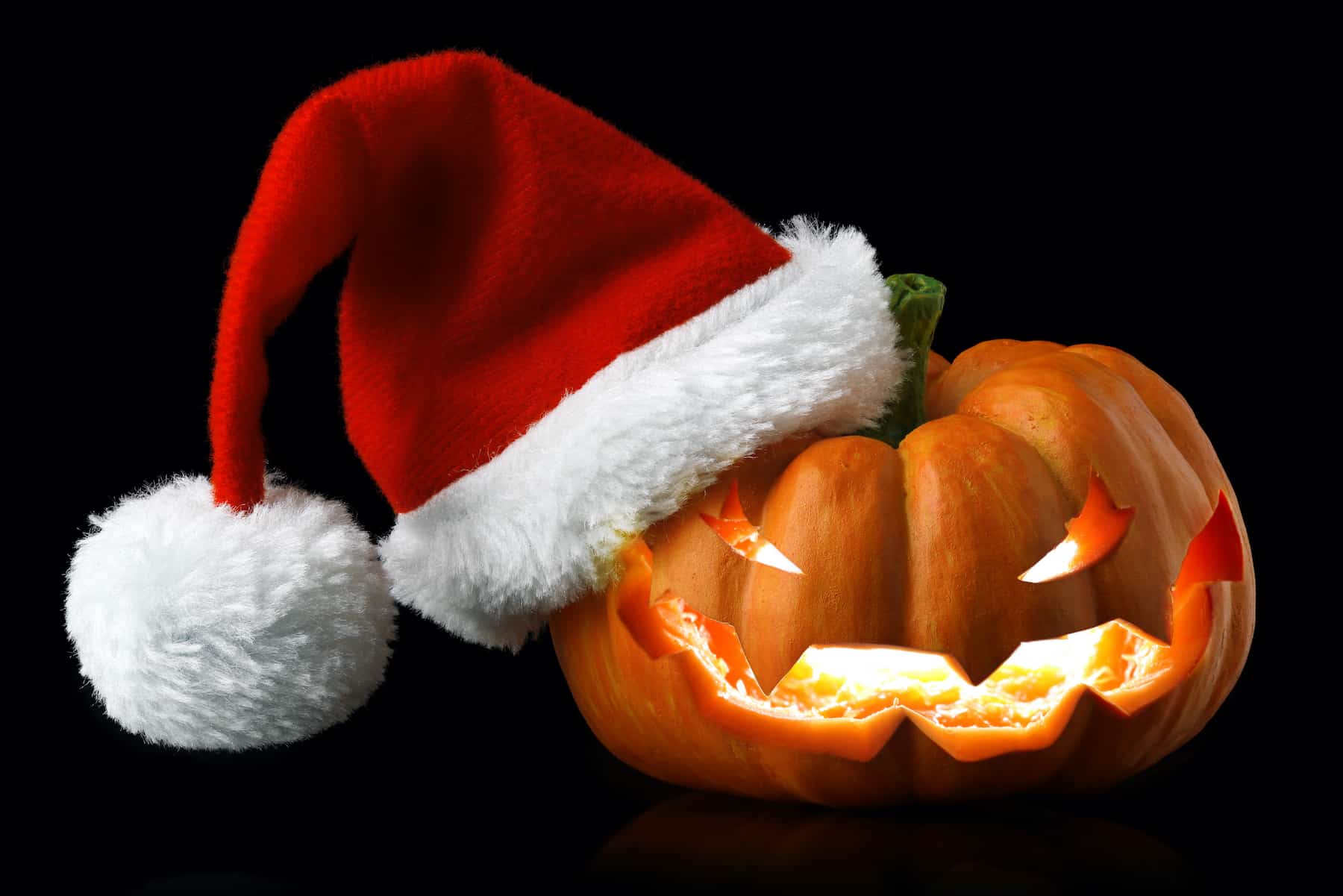 jack o lantern in a santa hat to symbolize early holiday shopping
