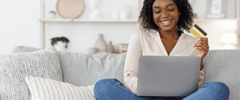 Young woman on a couch shopping online