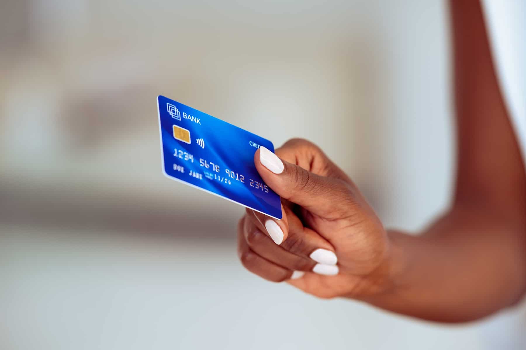 Credit card in woman's hand to illustrate Visa