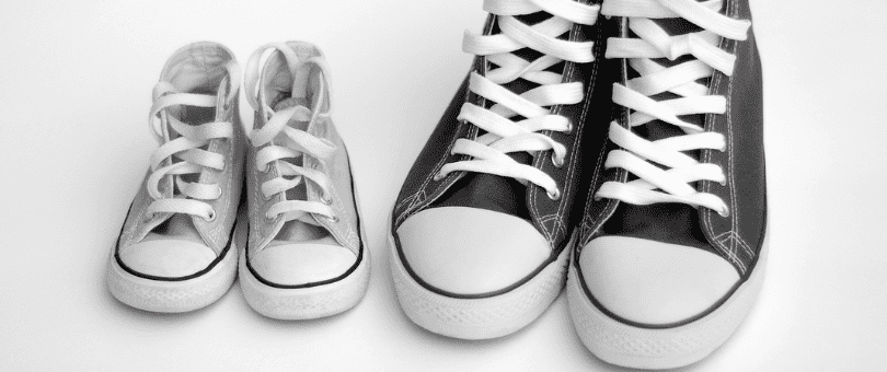 Big pair of Converse All-Star hightops next to a small pair to symbolize a move from a big company to Signifyd