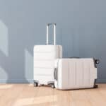 two white suitcases in an empty room to illustrate Signifyd March Pulse data post
