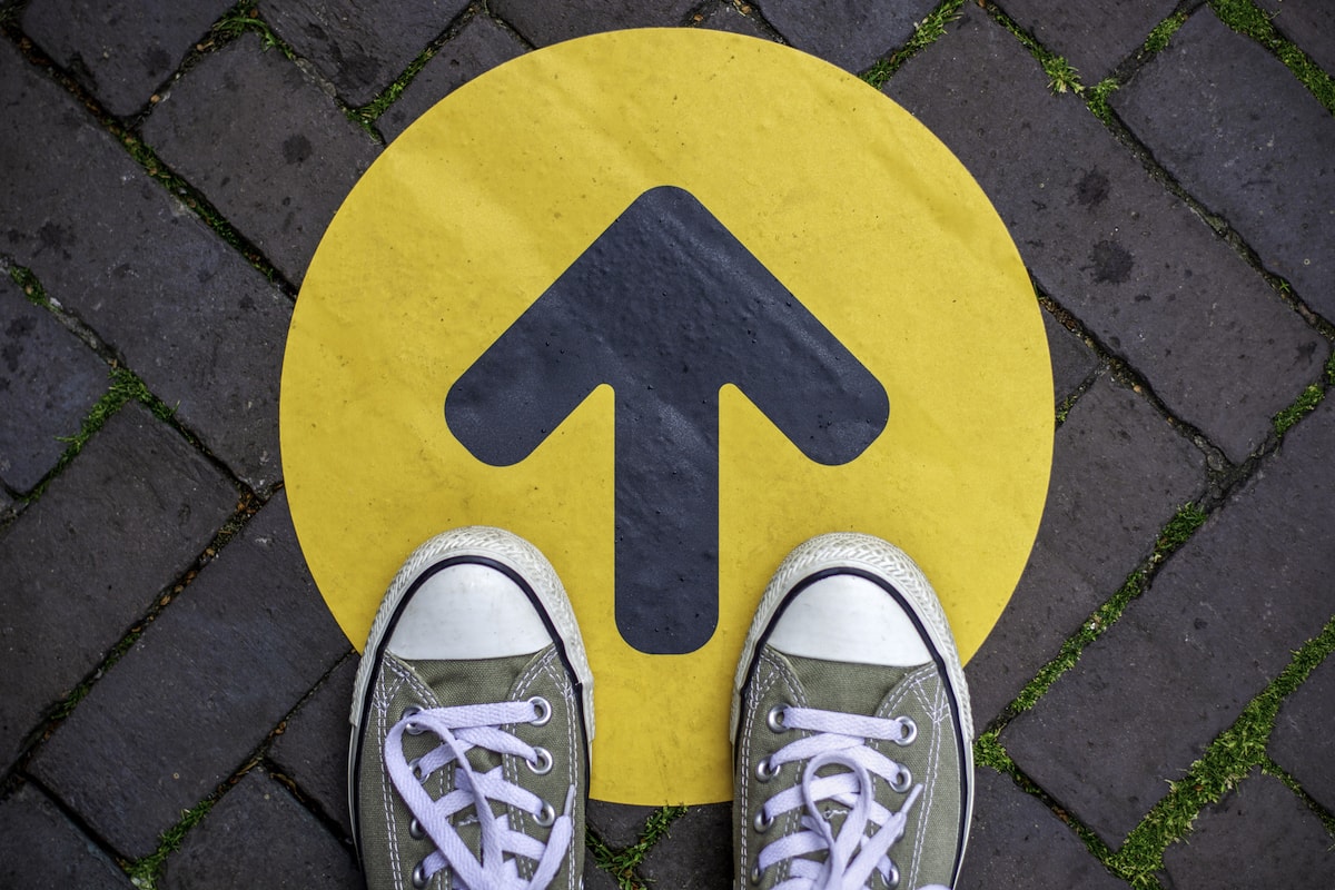 A pair of Converse standing on an up arrow - to symbolize Signifyd's commitment to upward mobility