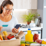 A woman unpacking grocery delivery to illustrate Signifyd August Ecommerce Pulse blog post