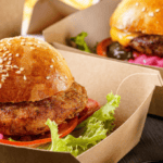 Cheeseburger and crispy chicken sandwhich to illustrate DoorDash delivery for story about first-party fraud and Signifyd data on Visa CE 3.0
