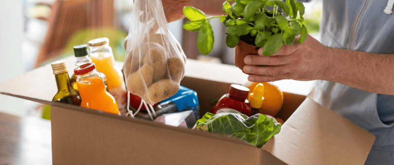 Man unpacking online grocery order, delivered to his home