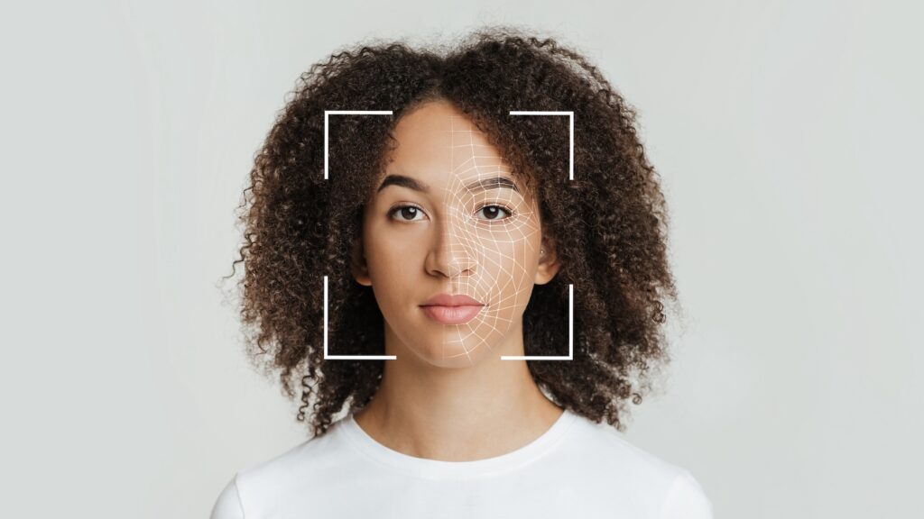 An African American woman's face being framed by a square and digital image to represent have a biometric scan.