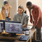 A team of fraud specialists exploring data on screens for use of AI in fraud detection blog post