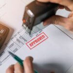 Legal looking document on a desk with a big, red stamp 