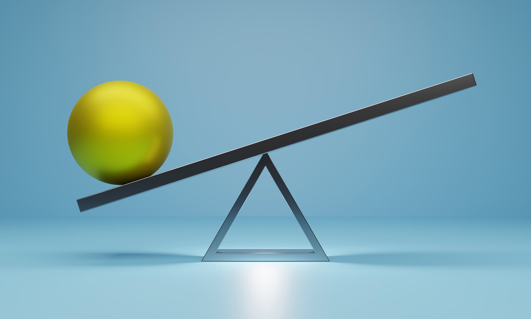 A green metal ball balancing on a seesaw to symbolize Signifyd's risk and reward pricing