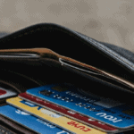 A wallet on a wooden table with several payment cards in it, to illustrate personalized payment blog post