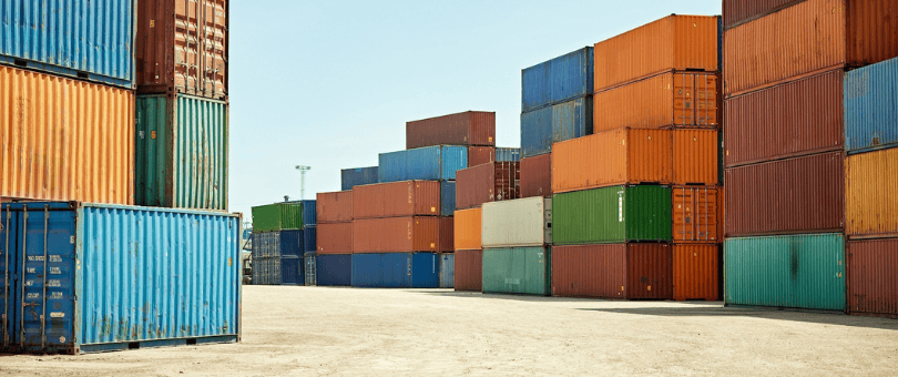 Shipping containers stacked in a port for Signifyd/Talker merchant survey blog
