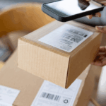 Photo of a woman scanning an ecommerce package with a phone, preparing to return the item