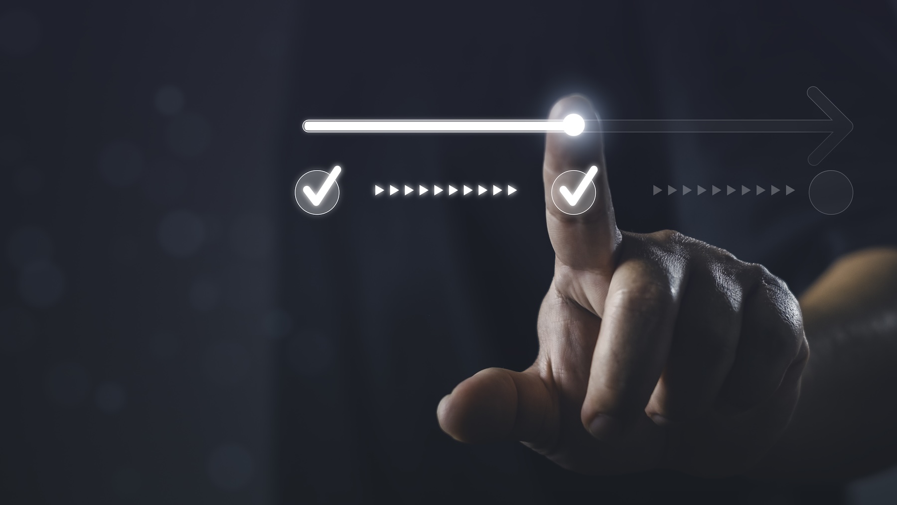 Photo of a hand, index finger extended, moving a a line from one check mark to another - symbolizing moving from approval to authorization