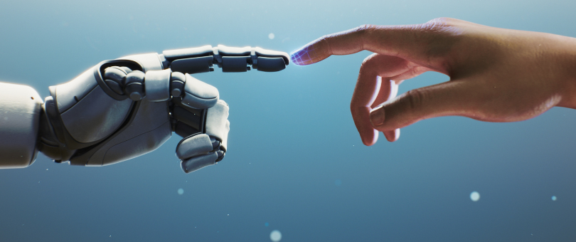 A robotic hand's extended index finger, touching a human hand's extended index finger