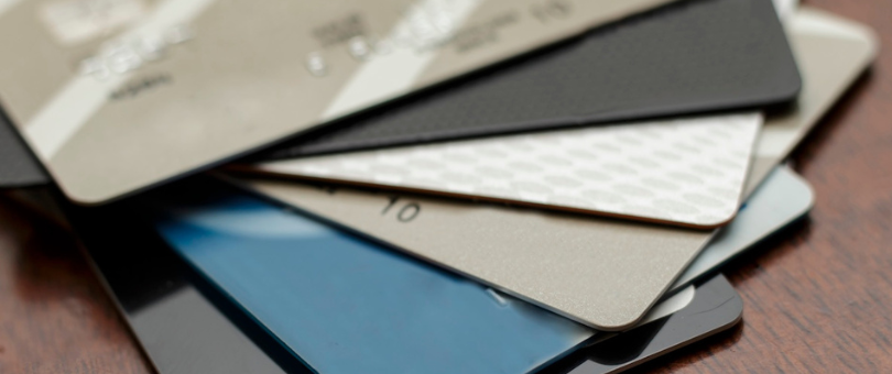 A close up of a stack of seven or eight credit cards to represent the issuing bank vs. acquiring bank blog post