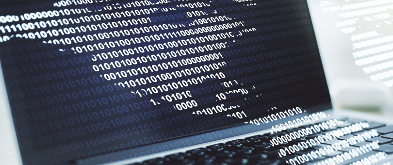 A laptop with binary code spilling out beyond it's screen for creepy agentic commerce fraud effect