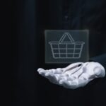 image of a robotic hand holding a shopping basket to symbolize agenti commerce in marketplaces
