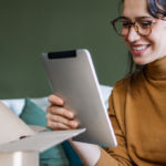 A woman obviously happy with a mug she received via delivery, her ecommerce post-purchase experience