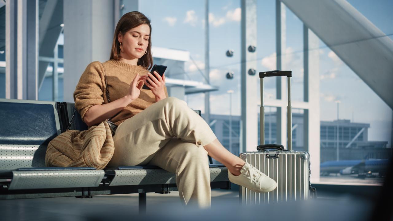 a traveller on their phone about to raise a chargeback