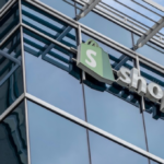 A picture of a Shopify sign on a modern, glass building in Ottawa