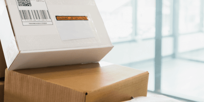A pile of ecommerce packages piling up on the returns counter at carrier's office