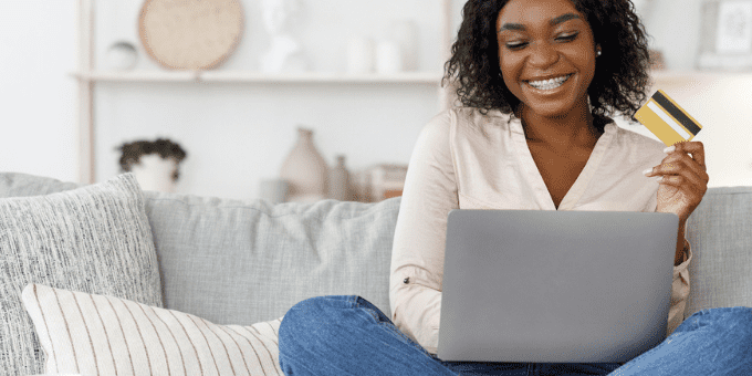 Young woman on a couch shopping online