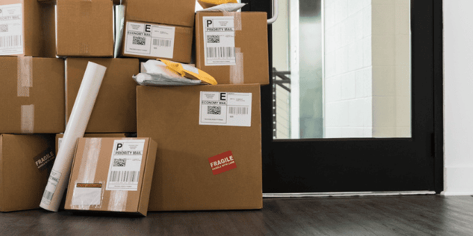 boxes piled high near the door for returns to illustrate return abuse blog post