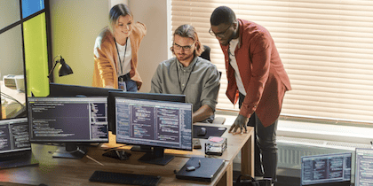 A team of fraud specialists exploring data on screens for use of AI in fraud detection blog post