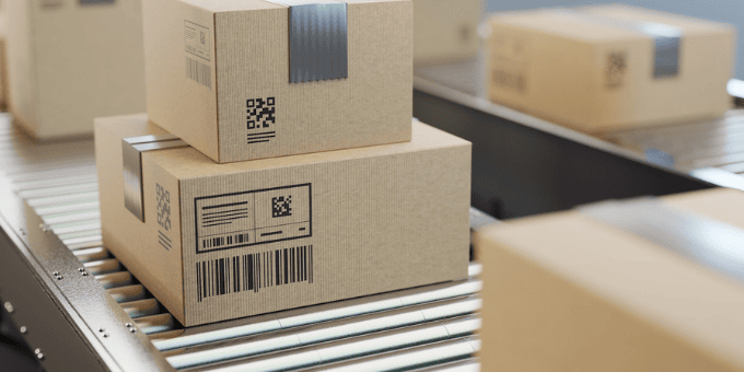 ecommerce packages on conveyer belt to illustrate de minimis blog