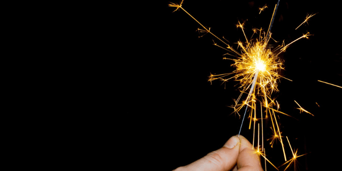 A spark held between thumb and forefinger