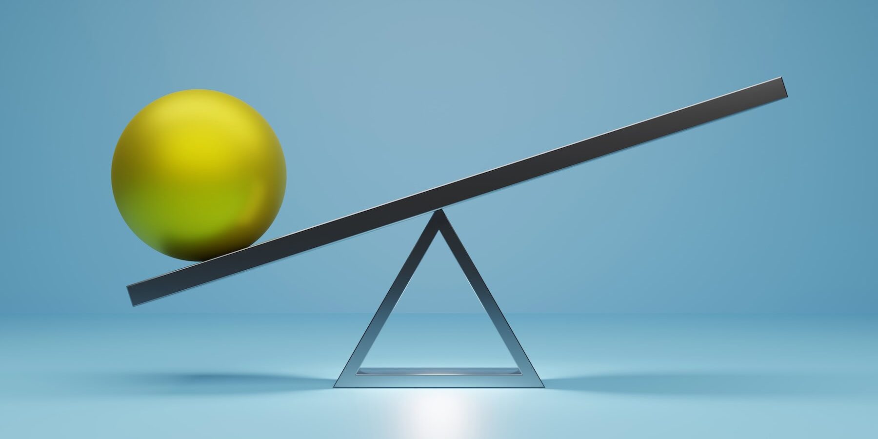 A green metal ball balancing on a seesaw to symbolize Signifyd's risk and reward pricing