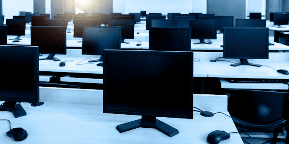 A room full of computer monitors to symbolize an industrialized global fraud ring