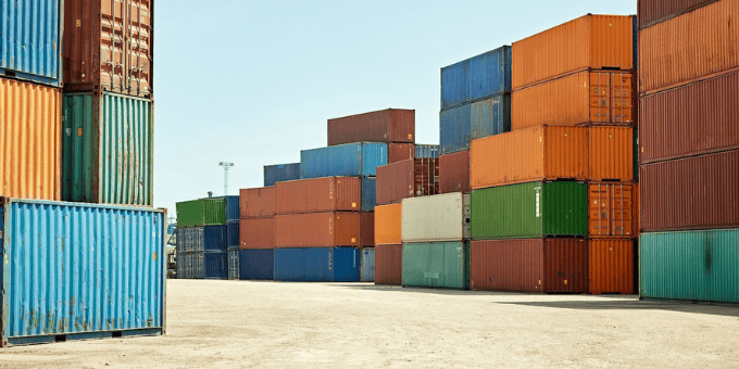 Shipping containers stacked in a port for Signifyd/Talker merchant survey blog