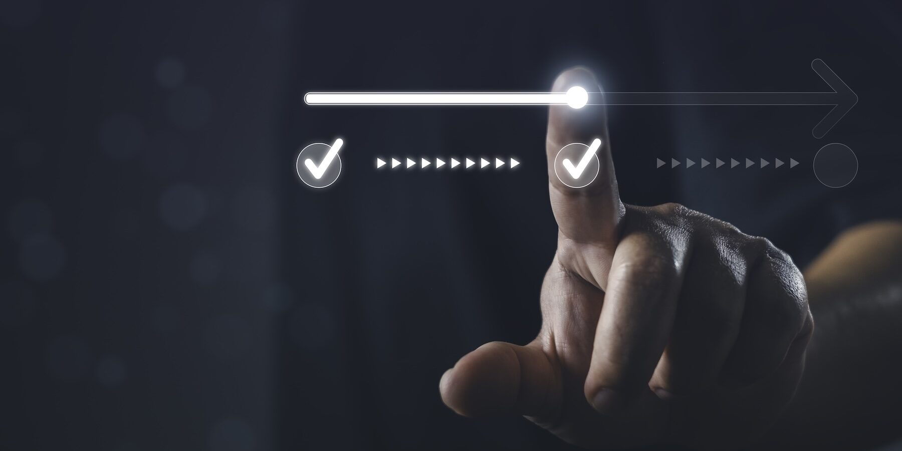 Photo of a hand, index finger extended, moving a a line from one check mark to another - symbolizing moving from approval to authorization