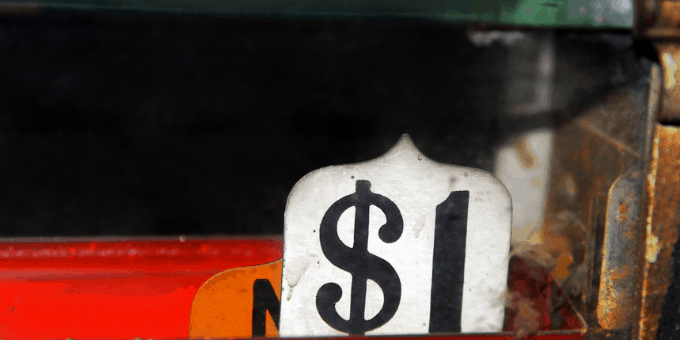 Old-time cash register showing a $1 sale