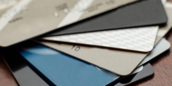 A close up of a stack of seven or eight credit cards to represent the issuing bank vs. acquiring bank blog post