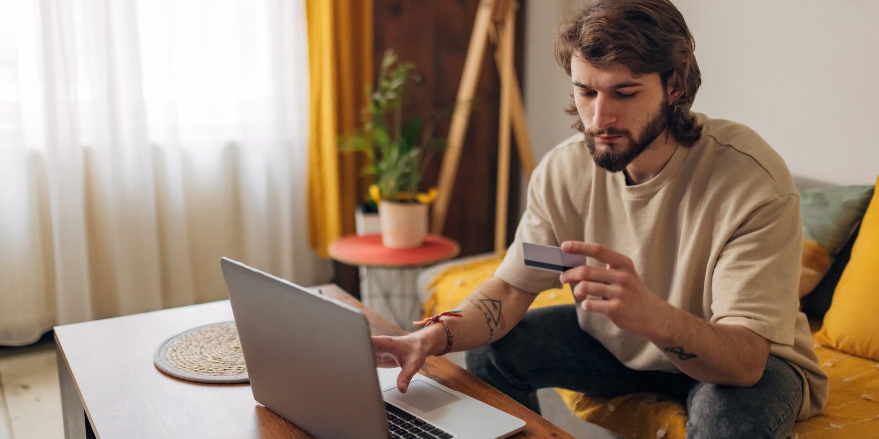shopper on his sofa looking puzzled to illustrate Signifyd's 3DS Myths and Realities in America blog post